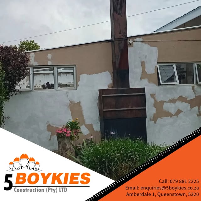 Exterior wall with plaster patched around a steel chimney